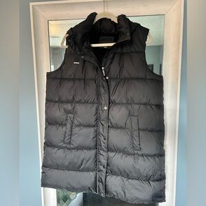Weatherproof long puffer vest with detachable hood.